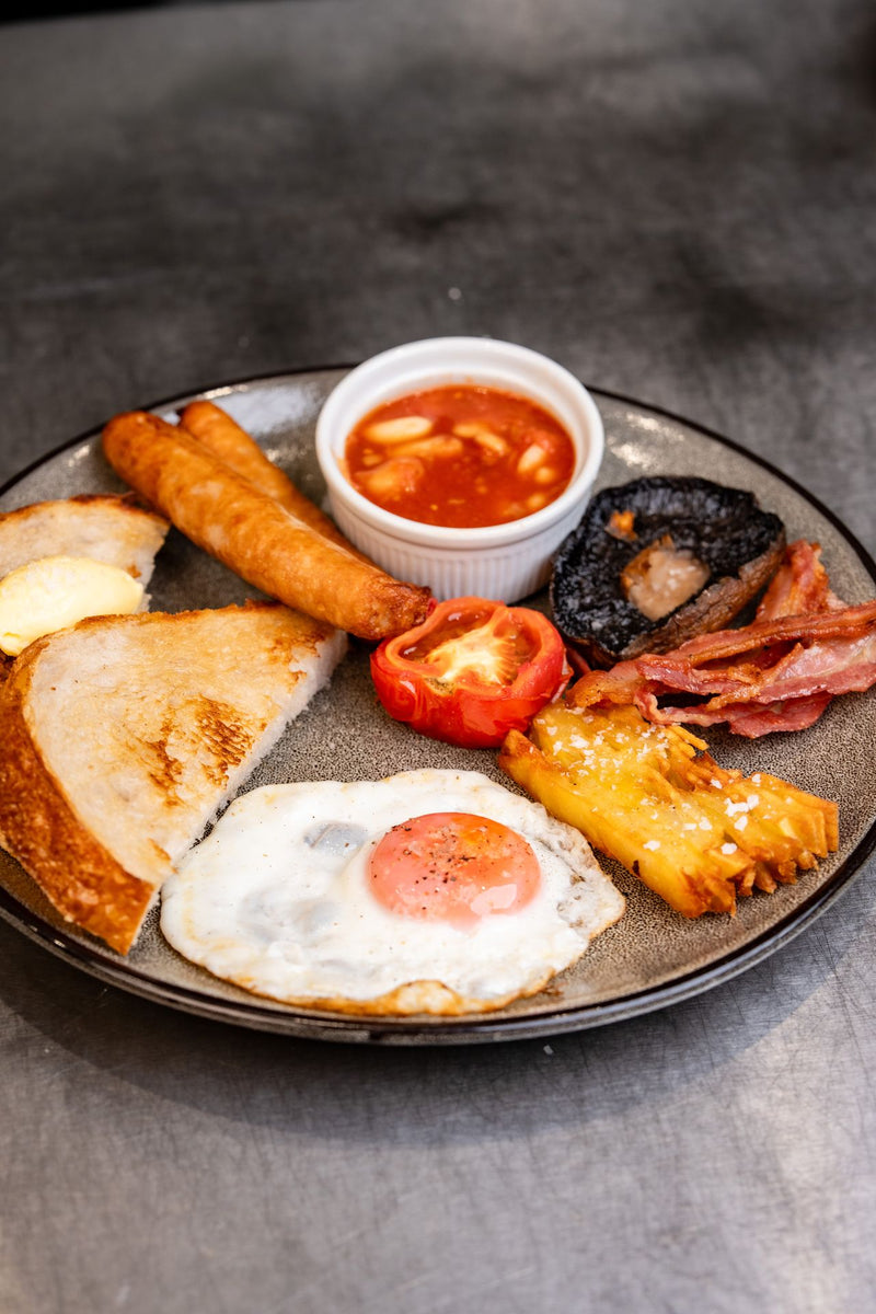 Cooked breakfast plate with sausages and sourdough served at The Focacceria Belfast