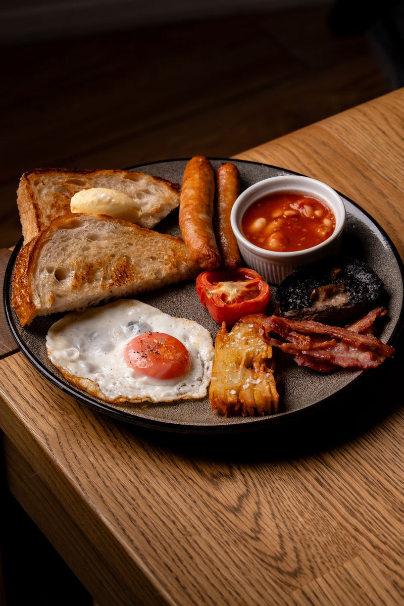 Artisan cooked breakfast served at The Focacceria Belfast on Boucher Road with sourdough toast, sausage, tomatoes and mushrooms