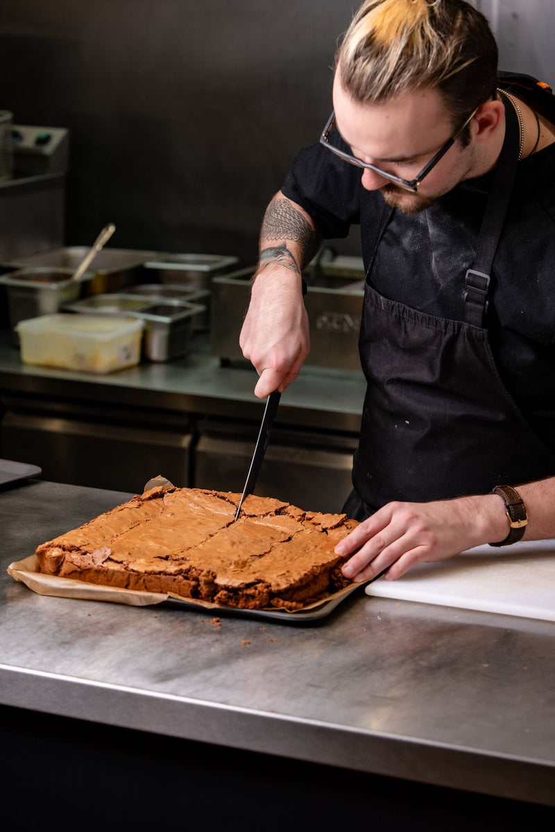 Tiramisu-style dessert being sliced in The Focacceria Belfast kitchen