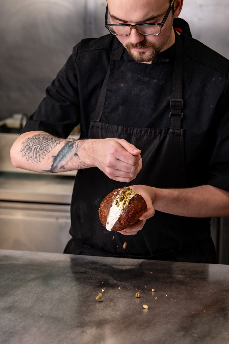Chef preparing food in The Focacceria kitchen, Upstairs at House Proud Furniture, Boucher Road Belfast